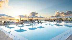 a pool with umbrellas and chairs